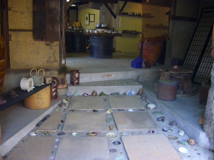 a shop in tokoname with pottery embedded in the floor
